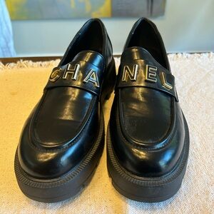 CHANEL Black Loafers with Gold Lettering